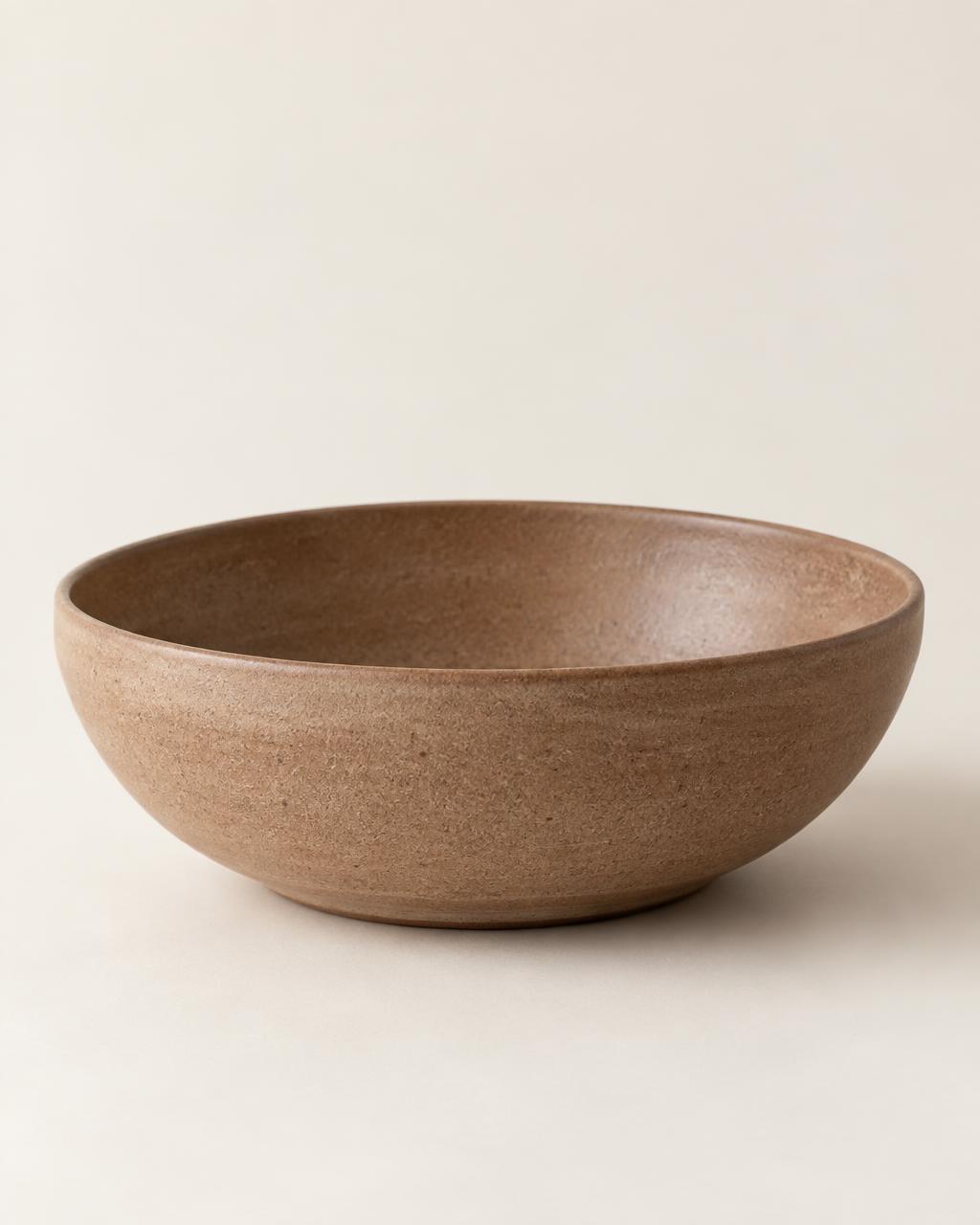 Mira wide shallow stoneware bowl in a soft clay brown matte glaze