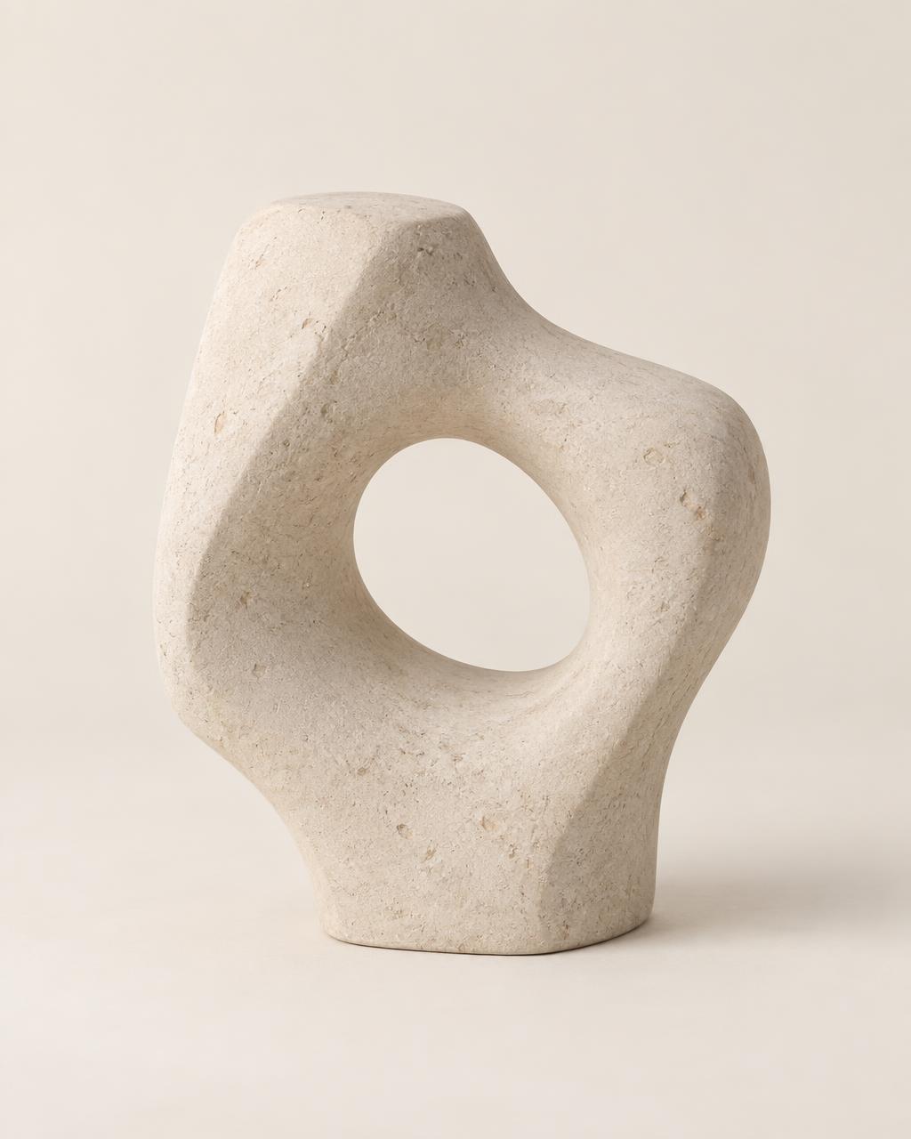 Quarry sculptural object hand carved from pale limestone with an open centre